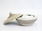 a small bowl with a lid and a spoon in it