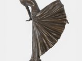 a bronze statue of a woman in a dress on a marble base
