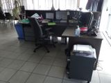 a desk with a chair and a computer on it