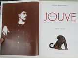 someone is holding a book with a picture of a man and a cat