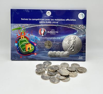 the euro coin is sitting next to a pile of coins