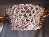 a white basket with a red and white design on it