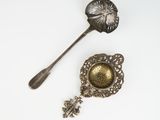 two spoons and a spoon rest on a white surface