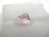 a close up of a pink diamond on a white surface