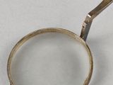 a magnifying glass with a gold handle on a table