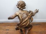 an image of a statue of a child holding a bird on a wooden floor