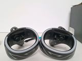 pair of black and silver headphones sitting on top of a white table