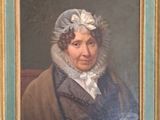 painting of a woman in a bonnet and coat in a green frame