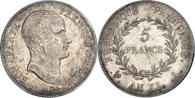 a silver coin with the head of a man in profile