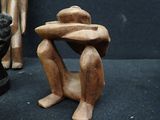 three figurines that are sitting on a black surface