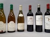 several bottles of wine are lined up in a row