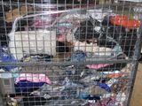 a metal cart with many items in it in a warehouse
