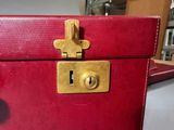 a red suitcase that has a lock on it