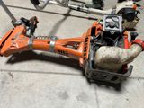 a chainsaw that is laying on the ground