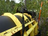 a yellow machine that is sitting in the grass