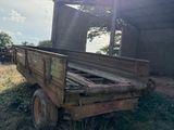a old wooden truck that is parked in the grass