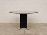 an image of a round table with a black base and a marble top