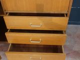 an image of a wooden cabinet with three drawers