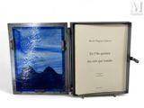 a picture of an open book with a picture of a mountain in it