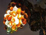 a lamp that has a bunch of glass flowers on it