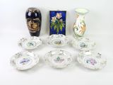 many different vases and plates that are sitting on a table