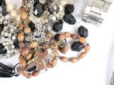 many different types of jewelry on a white surface
