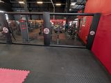 the inside of a gym with red walls and black flooring