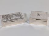 two silver boxes with a picture of a castle on them