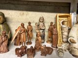 many figurines of different sizes and shapes on a shelf
