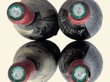 three bottles of wine are sitting on a reflective surface