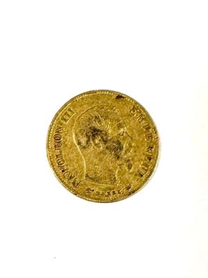 a close up of a gold coin on a white surface