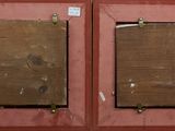 two wooden plaques mounted on a wall next to each other