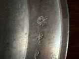 a close up of a metal pan on a wooden table