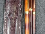 two pens and a case sitting on a table