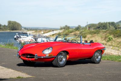 an image of a red sports car parked on the side of the road