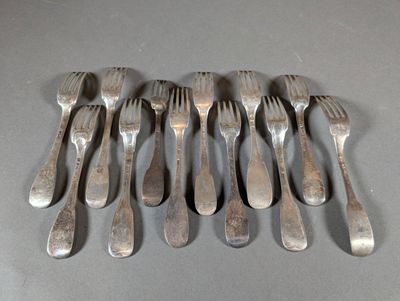 a lot of forks and spoons that are on a table