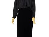 an image of a mannequin wearing a black dress on a wooden stand