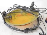 a yellow bowl with a dragonfly on it next to a pair of scissors