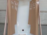 cardboard box on a pallet with a large white object inside of it