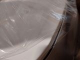 a toilet that is wrapped in plastic and sitting on the floor