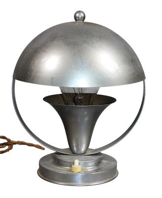 a silver lamp that is on top of a table