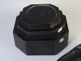 a small black object on a white surface next to a mouse