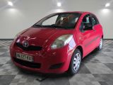 a picture of a red toyota yaris parked on a checkered floor