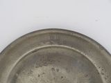 a silver plate that has a number on it