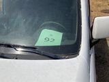 a white car with a green sticker on the windshield