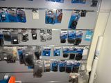 a wall of assorted electronics on display in a store