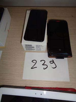 two cell phones sitting on a table with a price tag