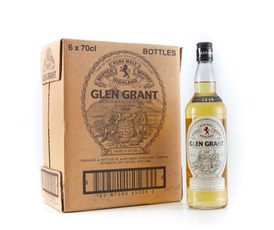 une bouteille de whisky Glen Grant à côté d'un carton
