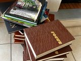 several books stacked on top of each other on a tiled floor