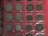 a lot of coins in a red case on top of a table